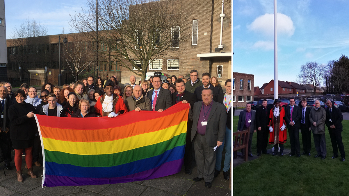 Councillors, staff and members of the public hold the Rainbow Flag