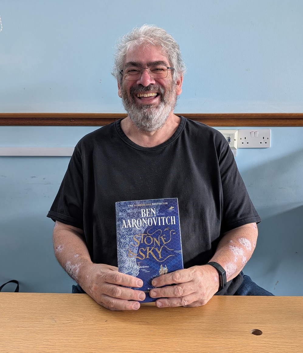 Ben Aaronovitch holding Stone and Sky at Hornchurch Library