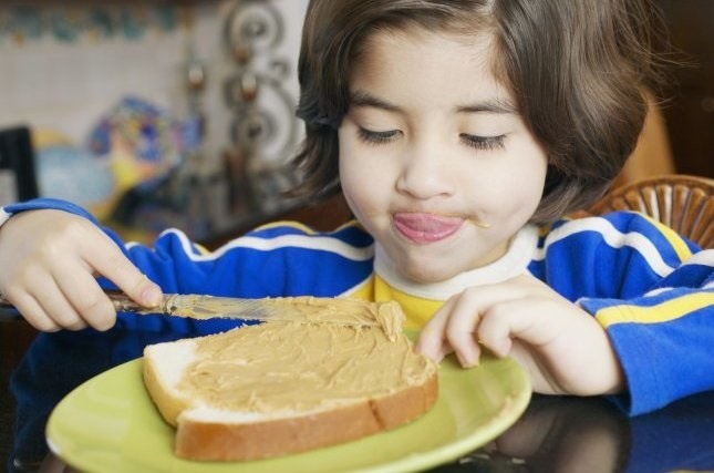 Boy eating a peanut butter sandwich