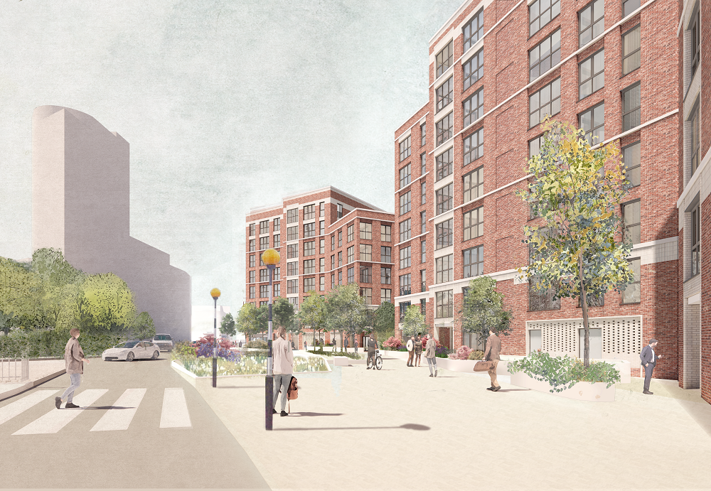 Image shows red brick building, pavement and green trees alongside road