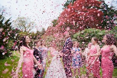Confetti throwing with couple and guests