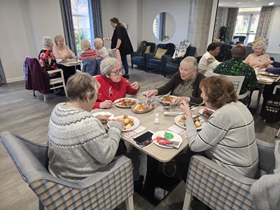 Elderly people enjoy a Christmas dinner