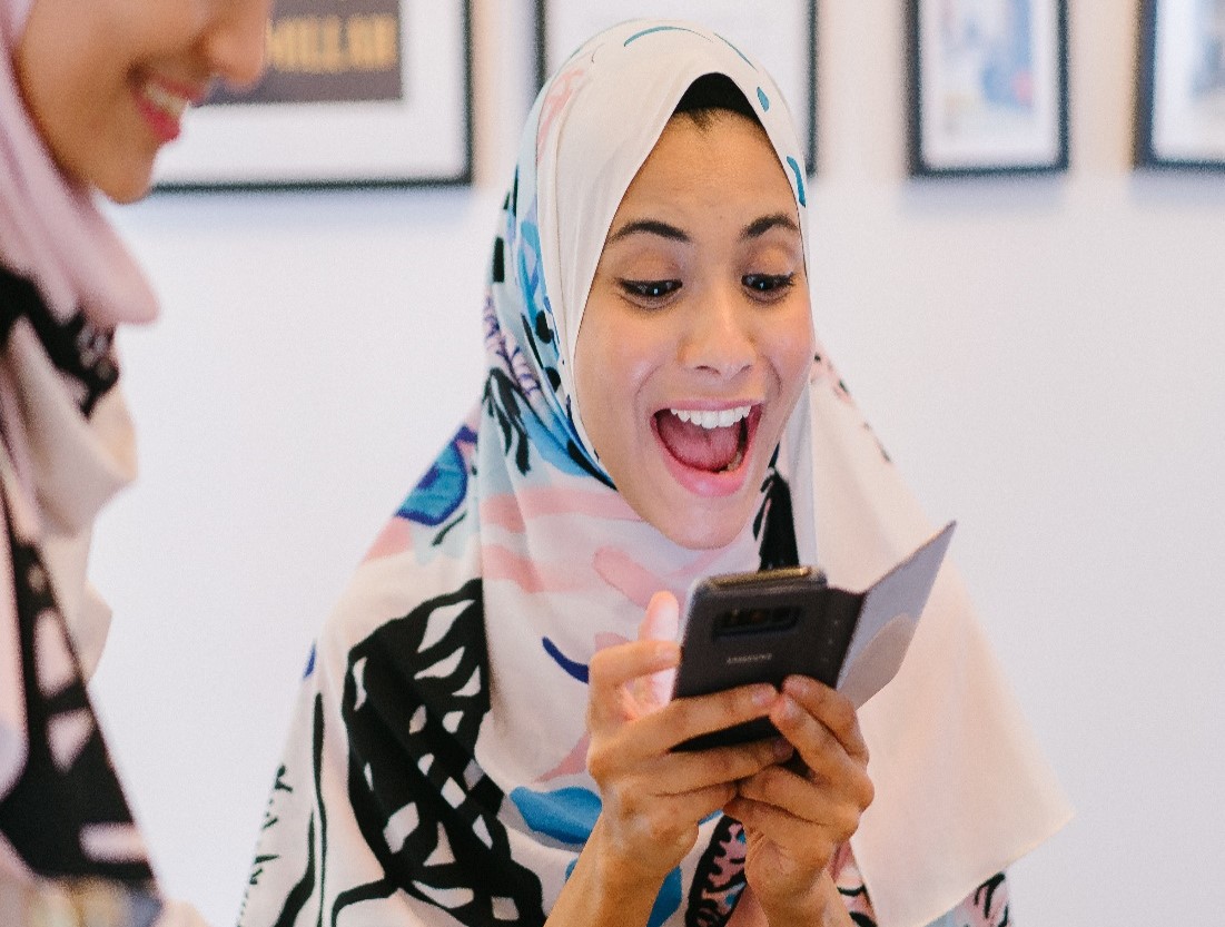 Girl smiling at phone