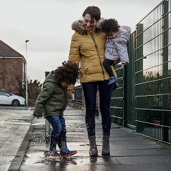 Fostering - Child jumping in puddle