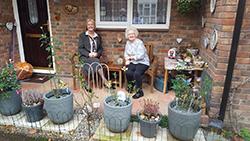 The Mayor takes a rest and enjoys 81 year old Gladys Collier’s patio garden.