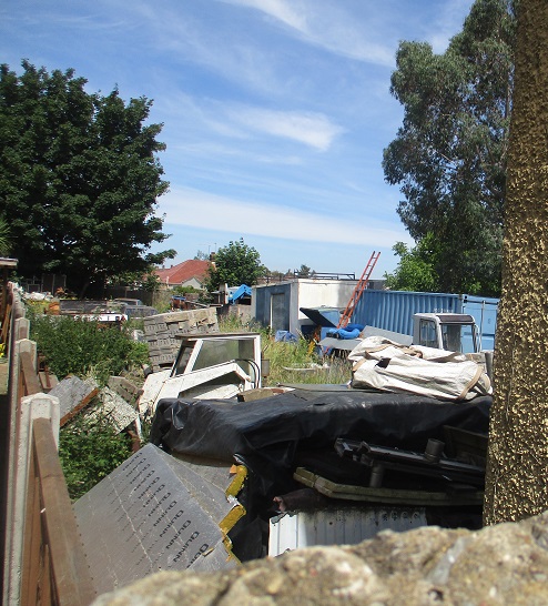 Cherry tree lane garden filled with engines and building materials