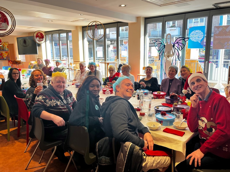 Smiling Salvation army volunteers at Christmas lunch