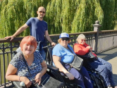 Yew Tree Centre - Manager and service users out in a park