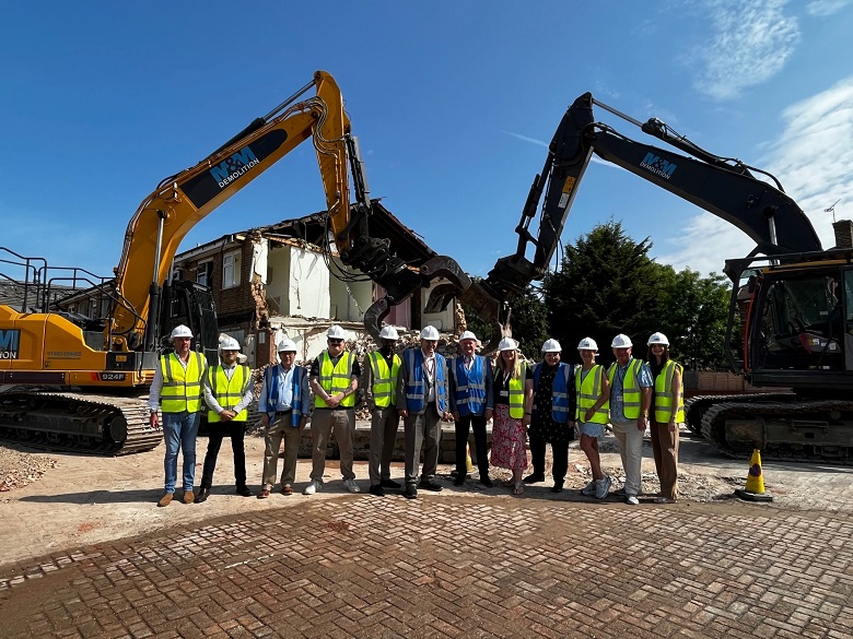 Group of people in safety clothing in front of the remains of abercrombie house