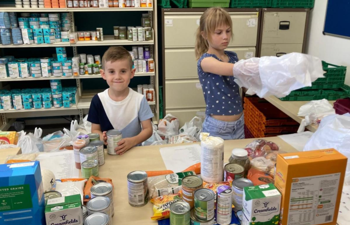 Children helping sort pantry packs